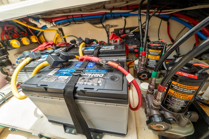 Lady Liberty Yacht Photos Pics Battery compartment of 2018 Chris-Craft Catalina 34, showcasing wiring and components.