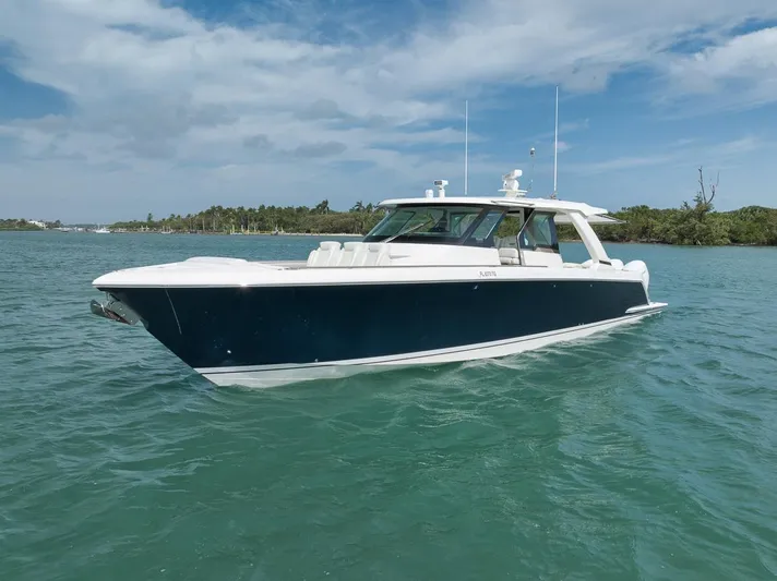 Sea Ya Yacht Photos Pics 2022 Tiara Sport 48LS luxury boat on calm water under a blue sky.