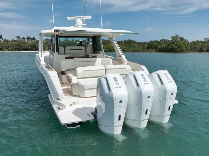 Sea Ya Yacht Photos Pics 2022 Tiara Sport 48LS boat with triple outboard engines on clear water.