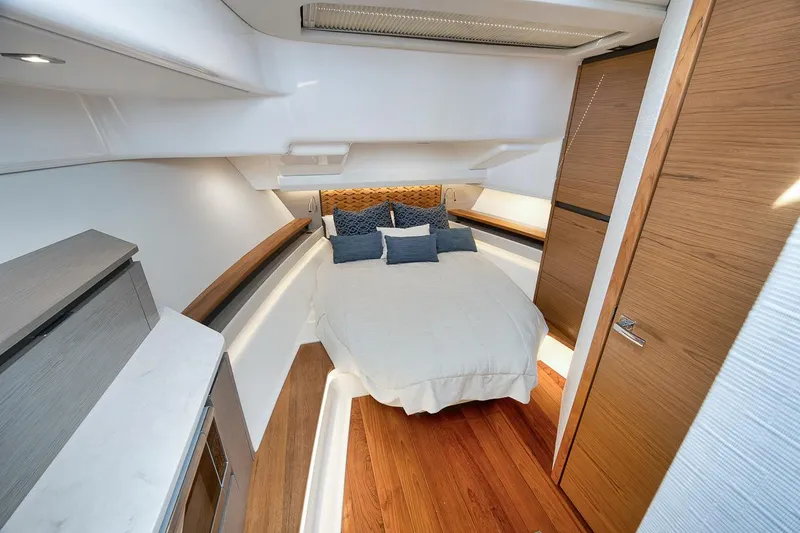 Sea Ya Yacht Photos Pics Luxurious cabin interior of 2022 Tiara Sport 48LS yacht with cozy bed and modern design.
