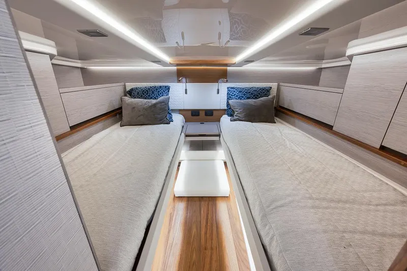 Sea Ya Yacht Photos Pics Luxurious 2022 Tiara Sport 48LS cabin interior with twin beds and modern lighting.