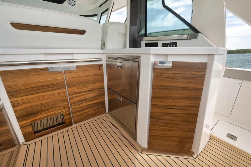 Sea Ya Yacht Photos Pics Luxurious 2022 Tiara Sport 48LS yacht interior with sleek wood cabinetry and modern design.