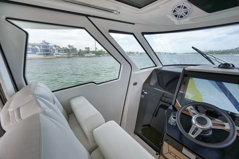 Sea Ya Yacht Photos Pics Interior view of 2022 Tiara Sport 48LS boat cockpit with modern steering and navigation system.