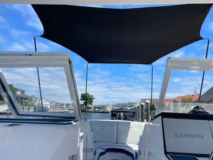  Yacht Photos Pics 2024 Sea Fox 288 Traveler boat with Garmin navigation, docked under a sunny sky.