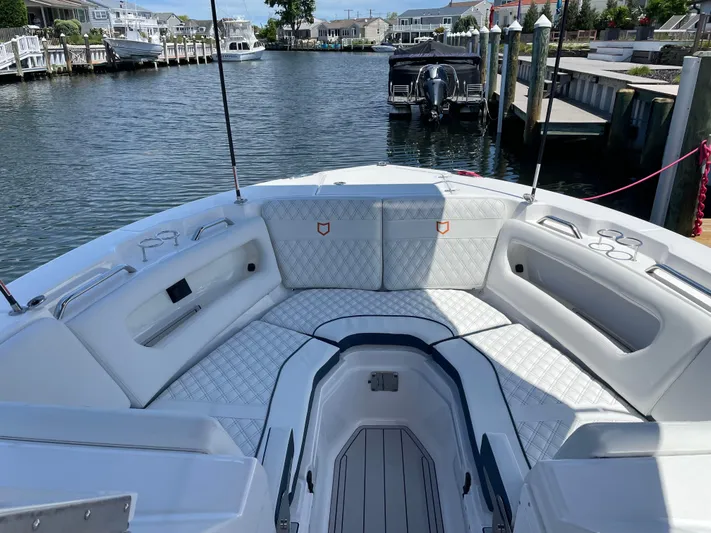  Yacht Photos Pics 2024 Sea Fox 288 Traveler boat interior with white seating, docked at a marina.