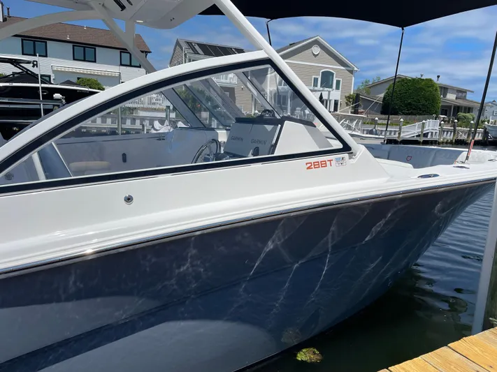  Yacht Photos Pics 2024 Sea Fox 288 Traveler boat docked near waterfront homes.