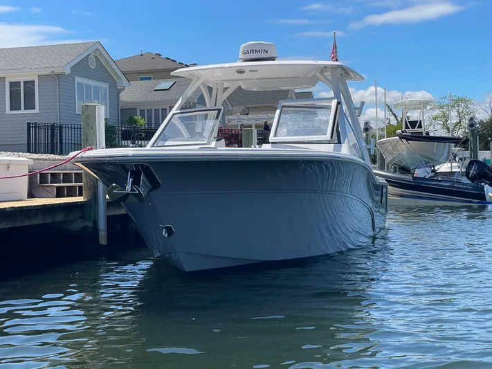  Yacht Photos Pics 2024 Sea Fox 288 Traveler boat docked near waterfront homes.