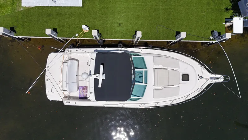 Reel Estate Yacht Photos Pics Overhead view of a 1998 Tiara Yachts 3500 Express docked by green grass.