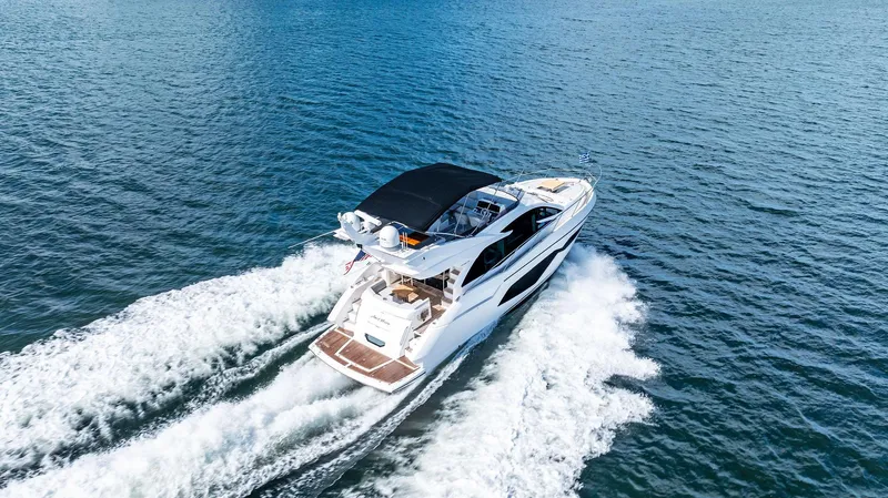 Almost Heaven Yacht Photos Pics 2021 Sunseeker Manhattan 52 yacht cruising on open water, aerial view.