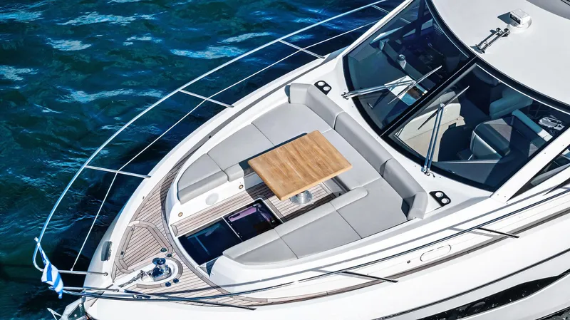 Almost Heaven Yacht Photos Pics Sunseeker Manhattan 52 yacht deck, 2021 model, with seating and table on blue water.