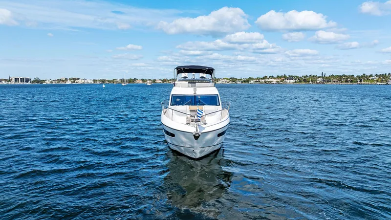 Almost Heaven Yacht Photos Pics 2021 Sunseeker Manhattan 52 yacht on open water under blue sky.