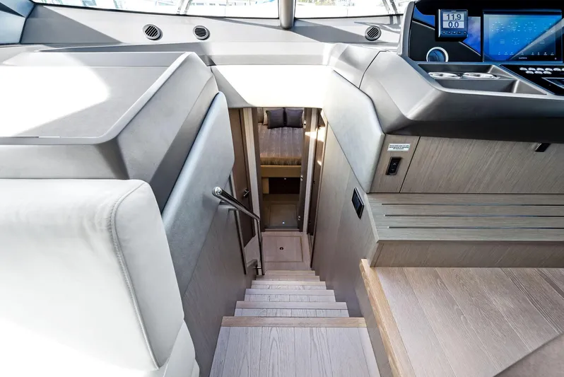 Almost Heaven Yacht Photos Pics Interior view of 2021 Sunseeker Manhattan 52 yacht, featuring modern staircase and control panel.