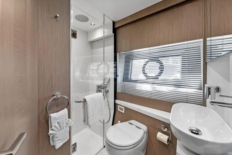 Almost Heaven Yacht Photos Pics Luxurious bathroom in 2021 Sunseeker Manhattan 52 yacht, featuring modern fixtures and elegant design.