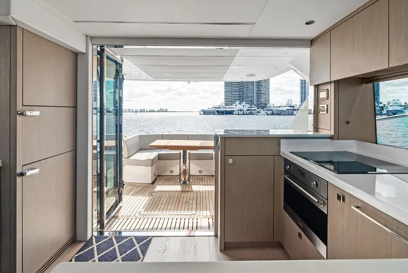 Almost Heaven Yacht Photos Pics Luxurious interior of 2021 Sunseeker Manhattan 52 yacht with modern kitchen and waterfront view.