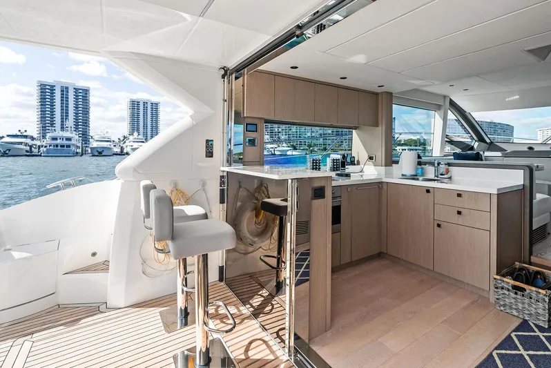 Almost Heaven Yacht Photos Pics Luxurious 2021 Sunseeker Manhattan 52 yacht interior with modern kitchen and waterfront view.