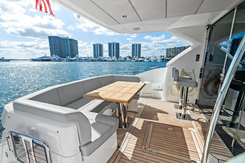 Almost Heaven Yacht Photos Pics Luxury Sunseeker Manhattan 52 yacht deck with seating, table, and ocean view, 2021 model.
