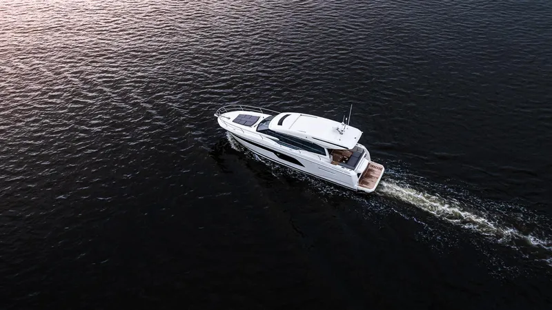 In Stock Yacht Photos Pics Aerial view of 2023 Prestige 520S yacht cruising on open water.