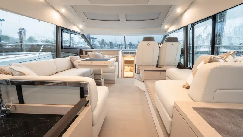 In Stock Yacht Photos Pics Luxurious interior of 2023 Prestige 520S yacht with elegant seating and panoramic windows.