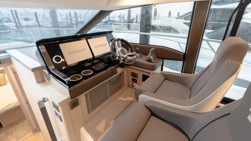 In Stock Yacht Photos Pics Luxurious 2023 Prestige 520S yacht helm with Garmin navigation displays and plush seating.