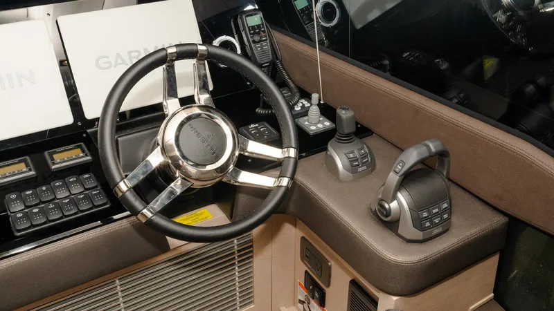 In Stock Yacht Photos Pics Control panel of 2023 Prestige 520S yacht with steering wheel and navigation equipment.