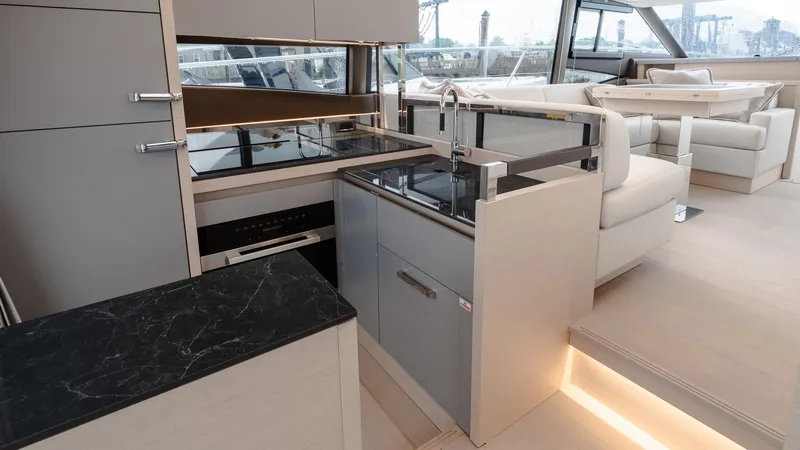 In Stock Yacht Photos Pics Modern kitchen interior on 2023 Prestige 520S yacht, featuring sleek cabinetry and elegant countertops.