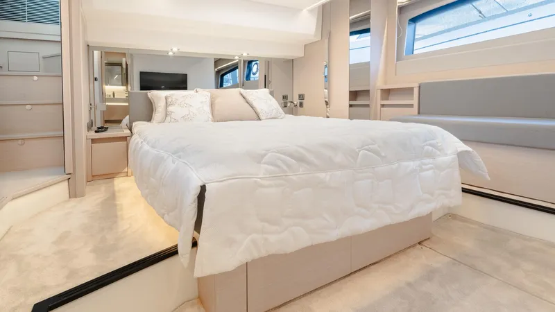 In Stock Yacht Photos Pics Luxurious bedroom interior of 2023 Prestige 520S yacht with elegant bedding and modern design.