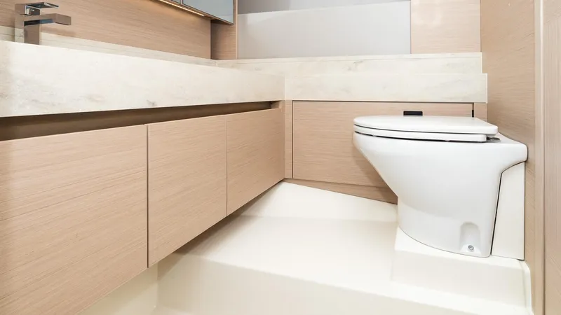 In Stock Yacht Photos Pics Modern bathroom interior in 2023 Prestige 520S yacht, featuring sleek cabinetry and a compact toilet.