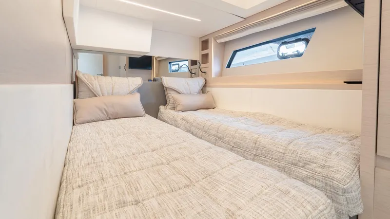 In Stock Yacht Photos Pics 2023 Prestige 520S yacht cabin with twin beds and modern interior design.