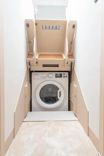 In Stock Yacht Photos Pics 2023 Prestige 520S laundry area with built-in washing machine in compact space.