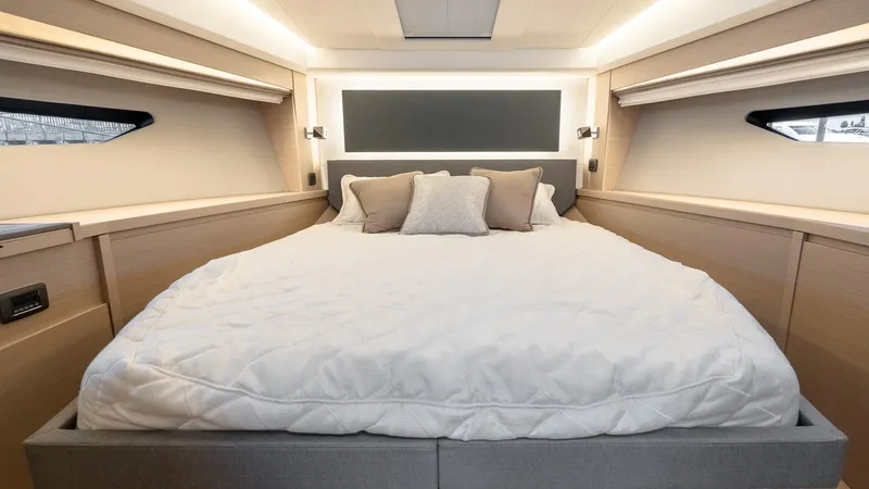 In Stock Yacht Photos Pics Luxurious bedroom interior of 2023 Prestige 520S yacht with elegant bedding and modern design.