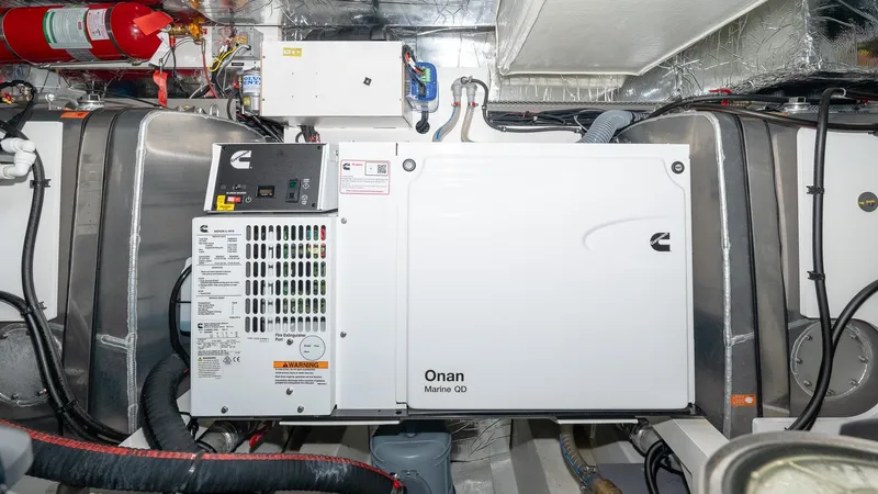 In Stock Yacht Photos Pics Engine room of 2023 Prestige 520S yacht with Onan generator and fire extinguisher.