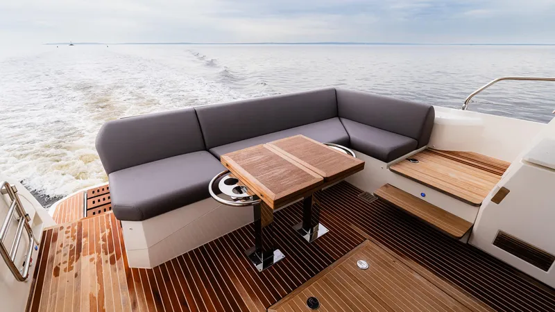 In Stock Yacht Photos Pics Luxurious 2023 Prestige 520S yacht deck with elegant seating and wooden flooring.