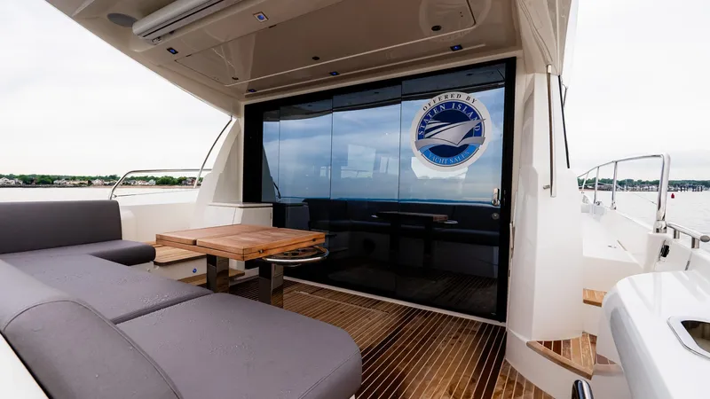 In Stock Yacht Photos Pics Luxurious 2023 Prestige 520S yacht with sleek deck seating and elegant wooden table.