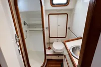 Bathroom interior of 1999 Custom Tasman 48 yacht with shower, toilet, and sink.