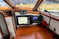 Interior of 1999 Custom Tasman 48 yacht with navigation equipment and wooden finish.
