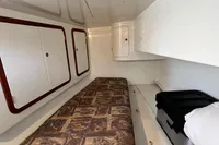 Interior cabin of 1999 Custom Tasman 48 yacht with bed and storage cabinets.