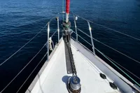 Bow of 1999 Custom Tasman 48 yacht on calm blue water.