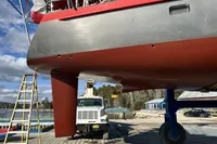 Custom Tasman 48 sailboat from 1999 on dry dock, showcasing hull and rudder.