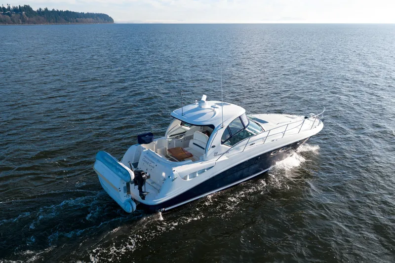  Yacht Photos Pics 2004 Sea Ray 390 Sundancer cruising on open water, showcasing sleek design and luxury.