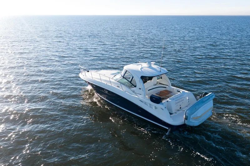  Yacht Photos Pics 2004 Sea Ray 390 Sundancer cruising on open water under clear skies.