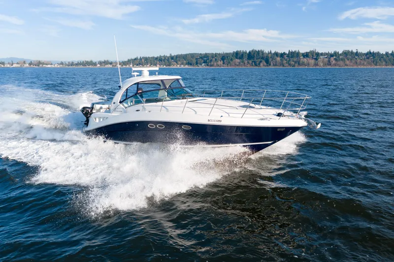  Yacht Photos Pics 2004 Sea Ray 390 Sundancer cruising on open water under clear skies.