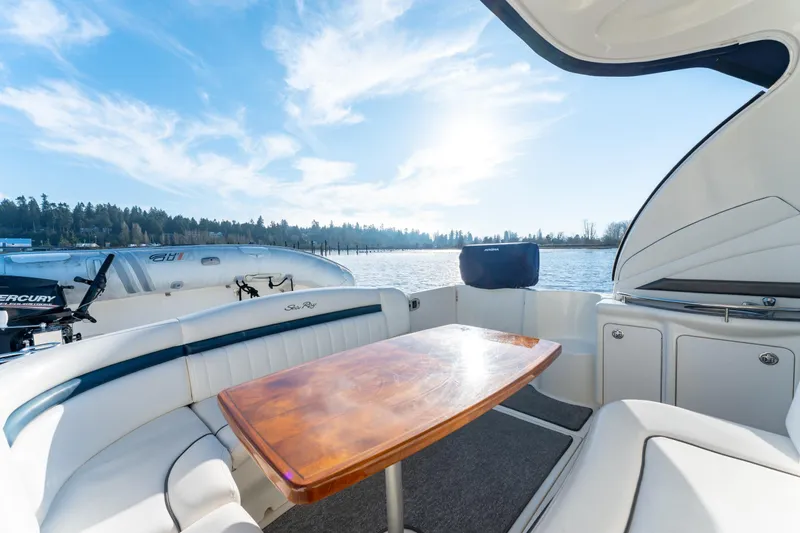  Yacht Photos Pics 2004 Sea Ray 390 Sundancer boat interior with wooden table, scenic water view.