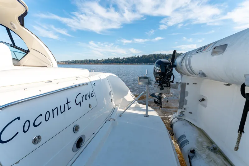  Yacht Photos Pics 2004 Sea Ray 390 Sundancer "Coconut Grove" on serene water with blue sky.