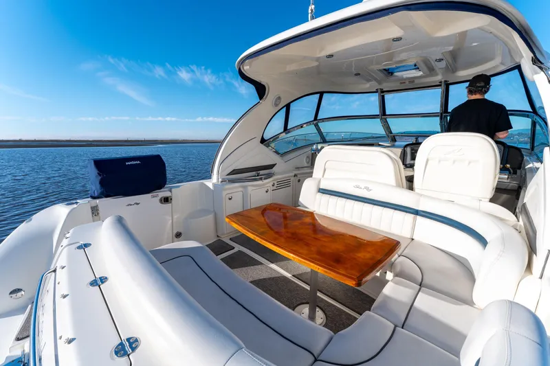  Yacht Photos Pics 2004 Sea Ray 390 Sundancer yacht interior with seating and table on a sunny day.