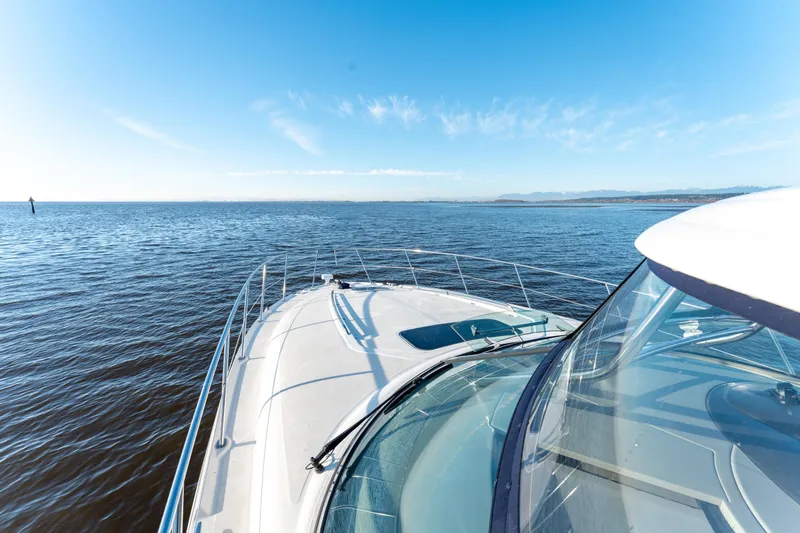  Yacht Photos Pics 2004 Sea Ray 390 Sundancer yacht cruising on open water under clear blue skies.