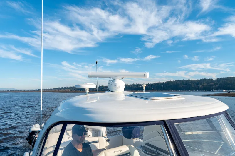  Yacht Photos Pics 2004 Sea Ray 390 Sundancer cruising on a sunny day with clear blue skies.