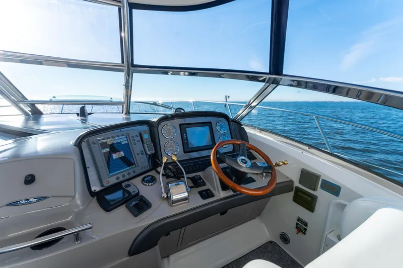  Yacht Photos Pics 2004 Sea Ray 390 Sundancer helm with navigation equipment and ocean view.