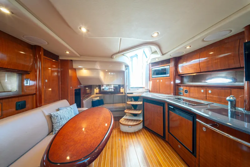  Yacht Photos Pics Luxurious interior of 2004 Sea Ray 390 Sundancer yacht with wood finishes and modern amenities.