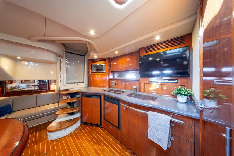  Yacht Photos Pics Luxurious interior of 2004 Sea Ray 390 Sundancer yacht with modern amenities and elegant wood finishes.