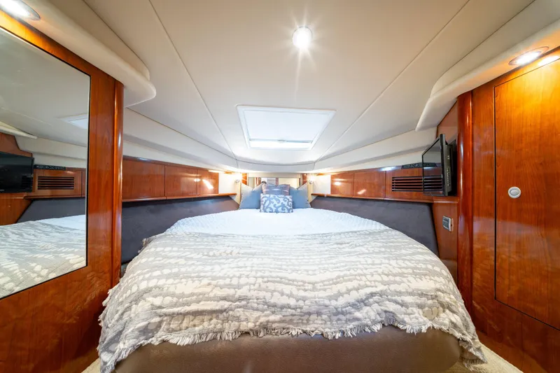  Yacht Photos Pics Luxurious cabin interior of 2004 Sea Ray 390 Sundancer yacht with cozy bedding.